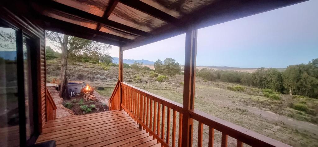 a porch of a house with a view of a field at The Lekker Plek - Private country cottage in Zuurbraak