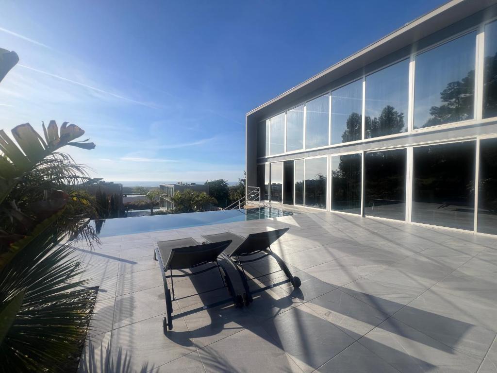 a patio with a table and chairs on a building at Casa da Arda, piscina exclusiva, entre mar e a montanha in Armada