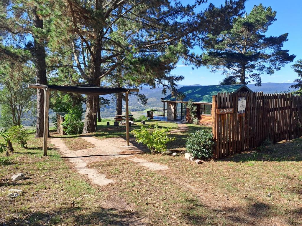 a garden with a wooden fence and a gate at Wild fig Cottage in Sedgefield