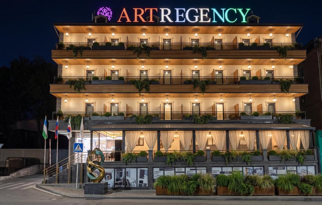 a hotel with a sign on the side of it at ART REGENCY Premium Hotel in Tashkent