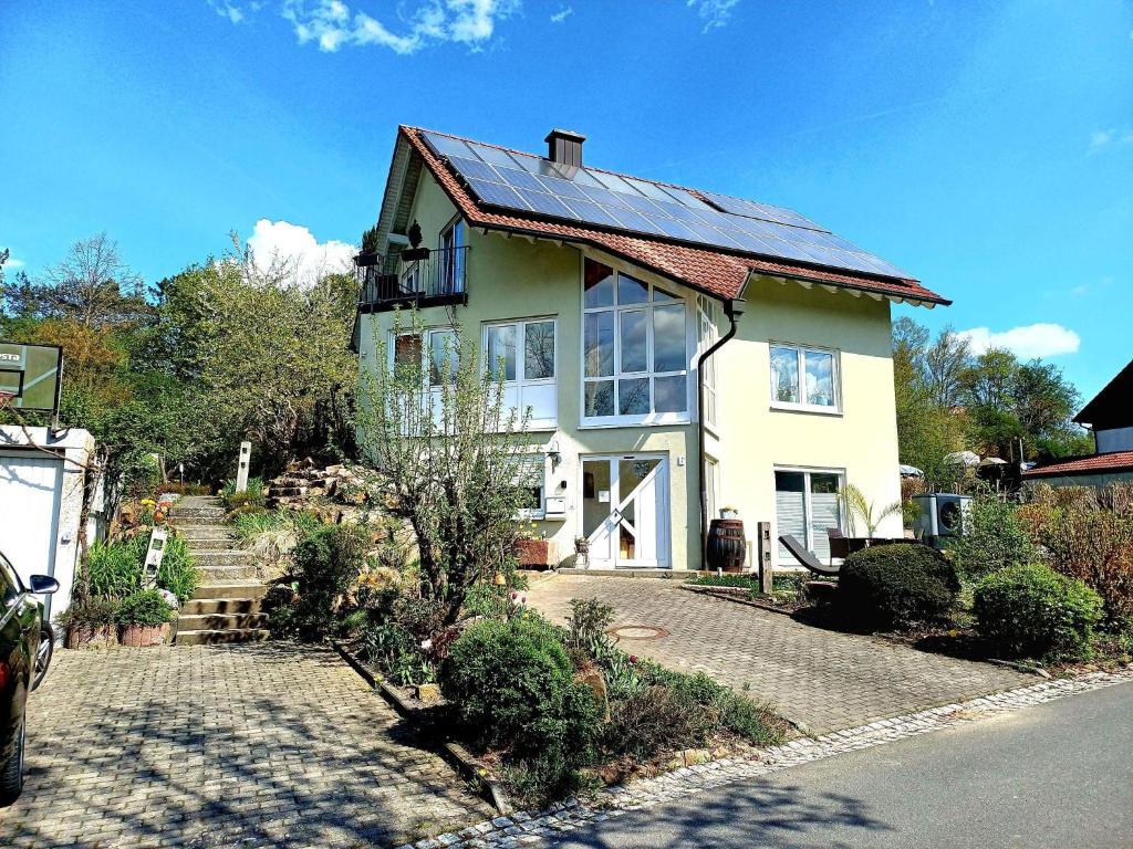 a house with solar panels on the roof at TauberGenuss in Werbach
