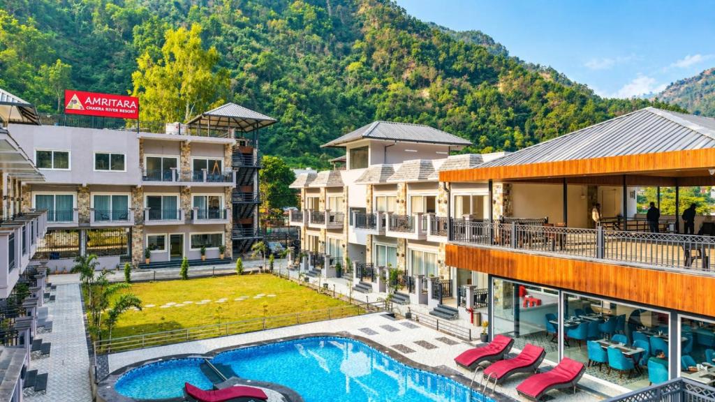 an aerial view of a hotel with a swimming pool at Amritara Chakra River Resort - Closest Luxury Resort to Neelkanth Temple in Mohan Chatti