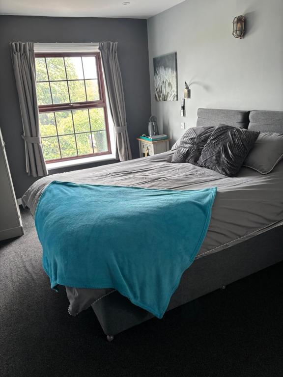 a bedroom with a large bed with a window at Plough inn in Great Mongeham