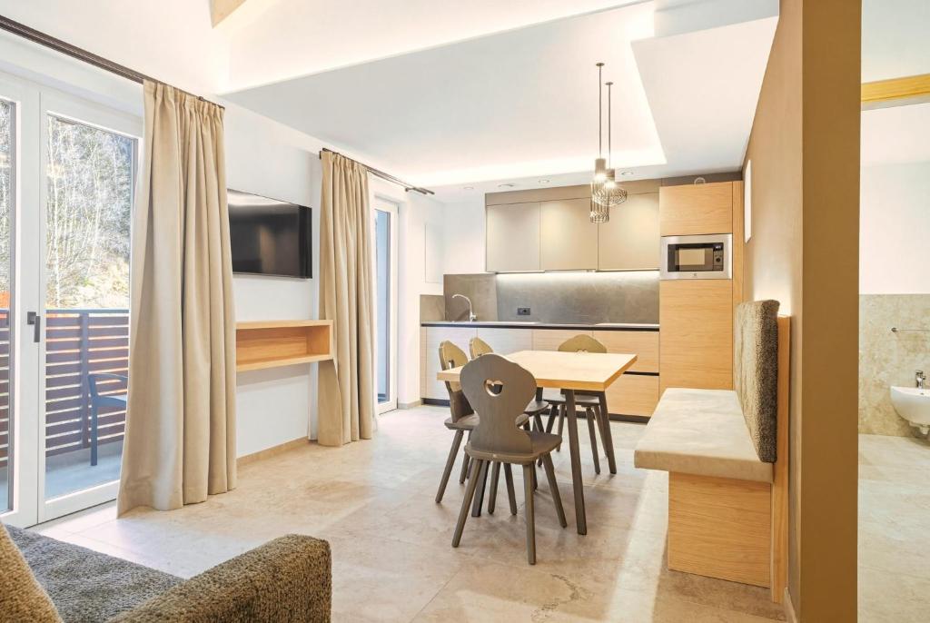 a kitchen and dining room with a table and chairs at Residence Diamant in Andalo
