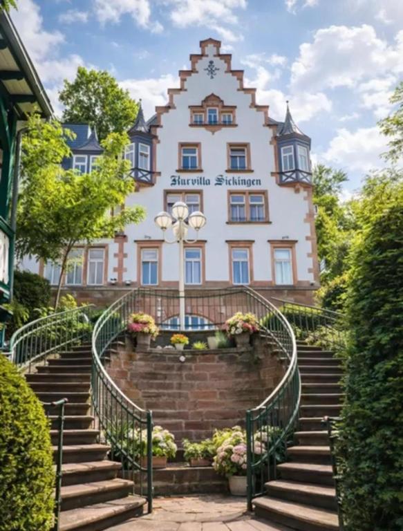 a building with stairs in front of it at Kurvilla Hotel & Apartment in Landstuhl