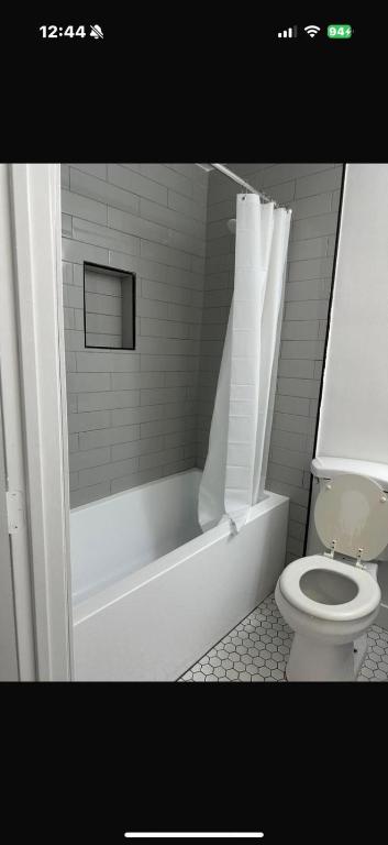 a bathroom with a white tub and a toilet at Central LA Shared Living #2 in Los Angeles