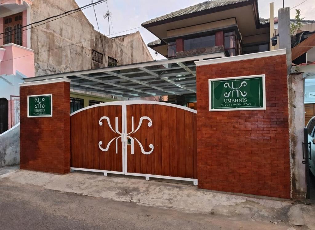 a wooden gate in front of a building at Umahnis Villa in Ngabean