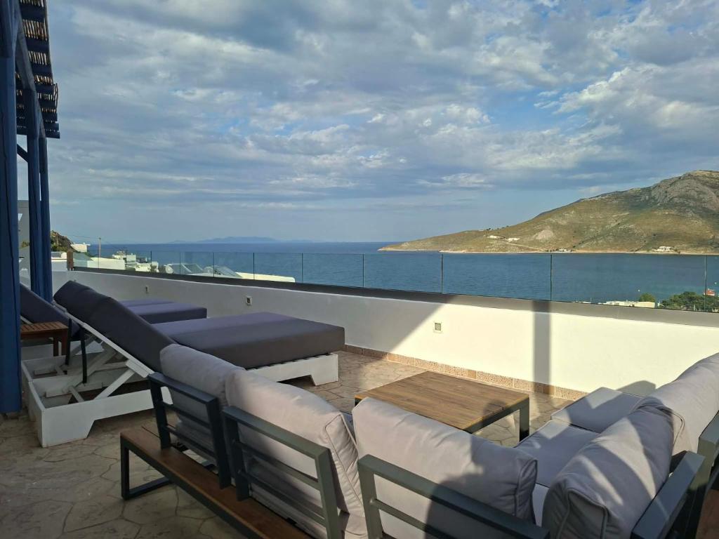 a balcony with couches and a view of the ocean at THALASSA in Livadia