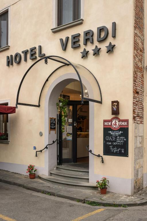 a hotel building with a sign on the front of it at Hotel Verdi Pisa in Pisa