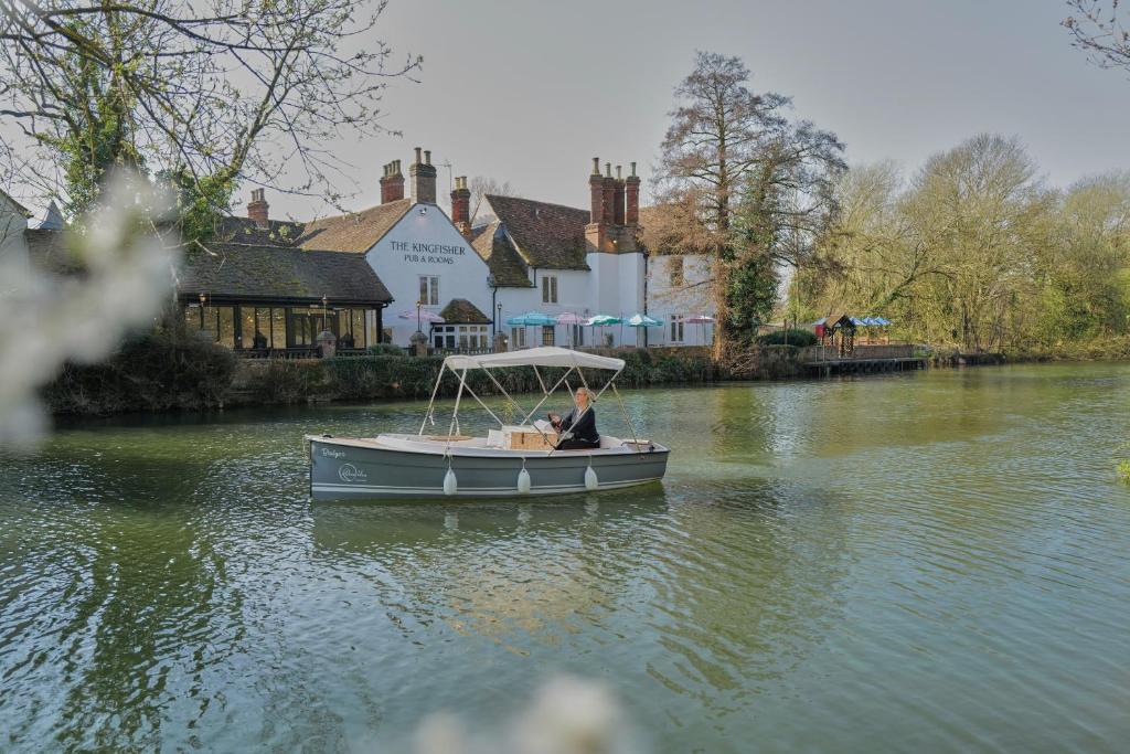 a man in a boat on a river at The Kingfisher in Bedford