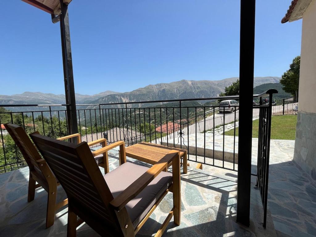 a balcony with a chair and a view of the ocean at Panorama House in Pramanta
