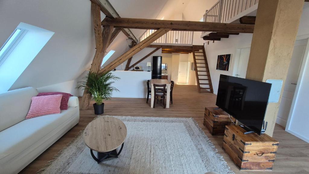 a living room with a couch and a tv and a table at Ferienwohnung Melle - Westerhausen in Melle