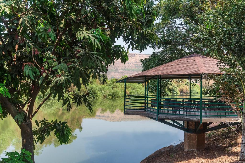 a gazebo sitting on top of a body of water at Palmwoods Retreat in Pune
