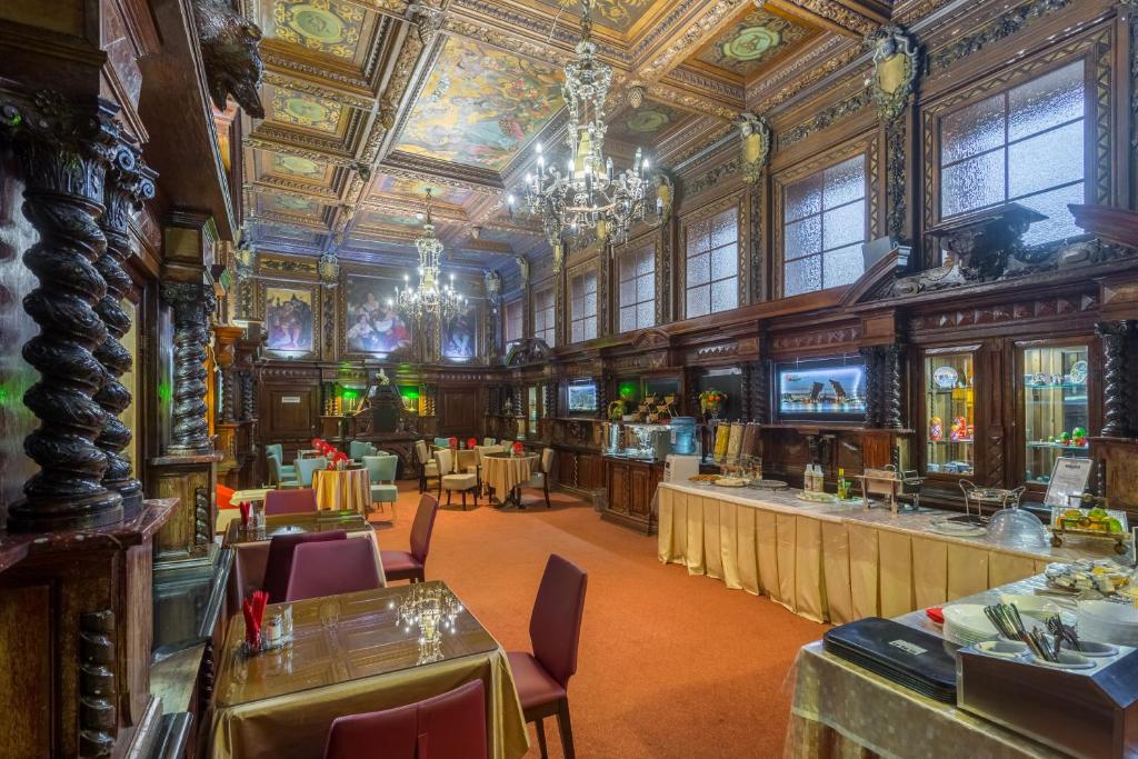 a large room with a restaurant with tables and chairs at Big Marine in Saint Petersburg