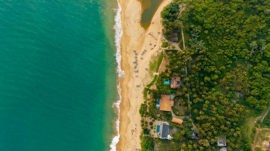 an overhead view of a beach with trees and the ocean at Ranna Beach House in Ranna