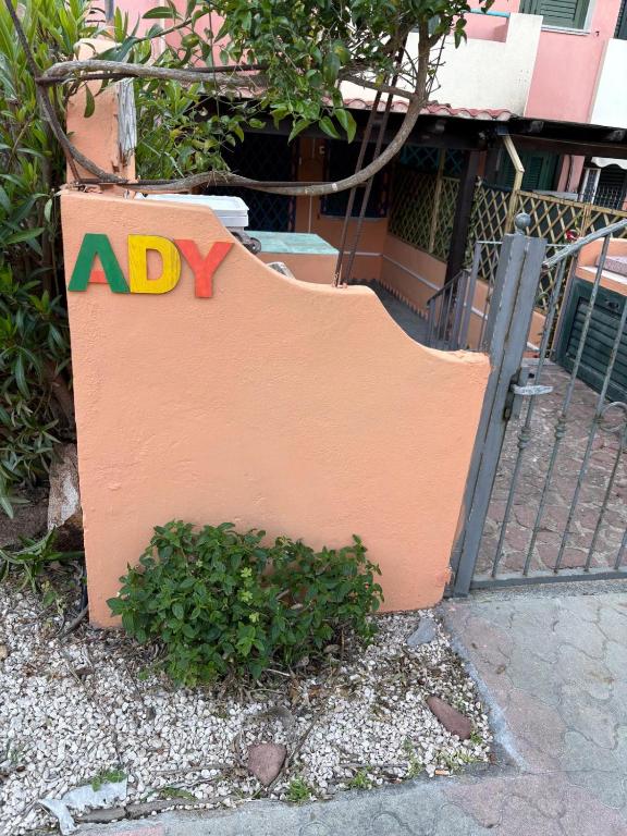 a sign with the wordidy on it next to a fence at Casa Ady in San Teodoro