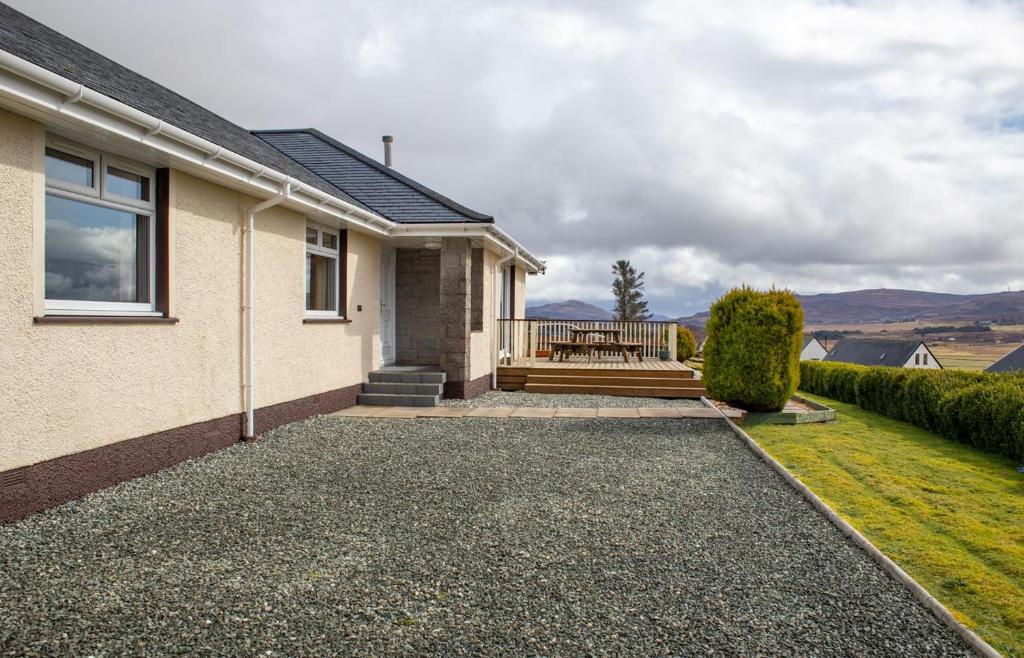 a house with a porch and a patio at Skeabost View in Tole