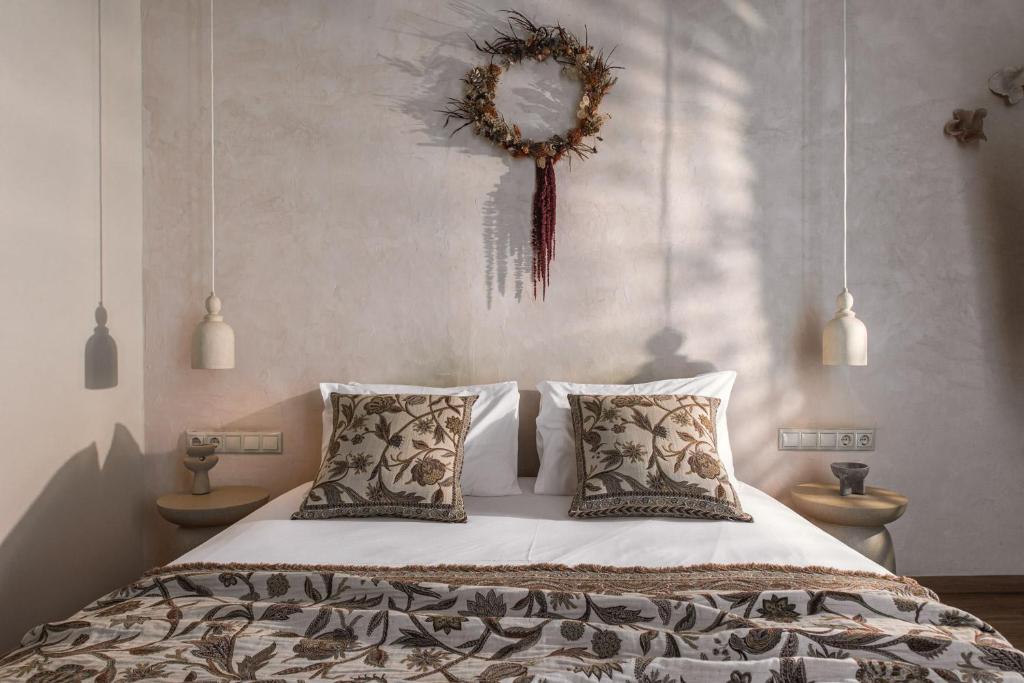 a bedroom with a bed with pillows and a mirror at Ederlezi Boutique Hotel in Athens