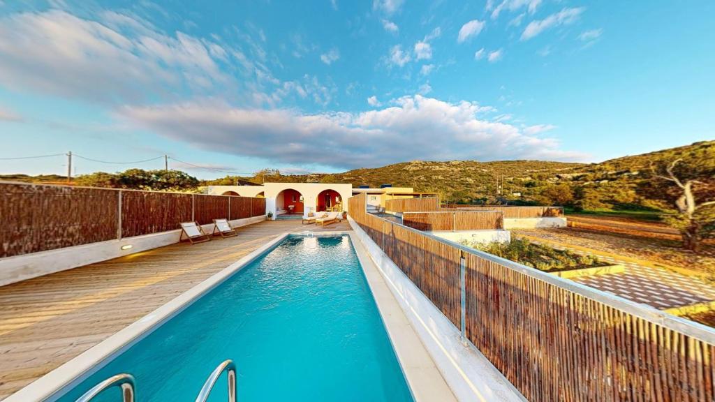 a swimming pool in the middle of a house at Okto in Archangelos