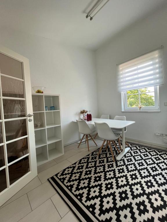 a white room with a table and chairs and a window at Ferienwohnung Monteurwohnung in Wadern