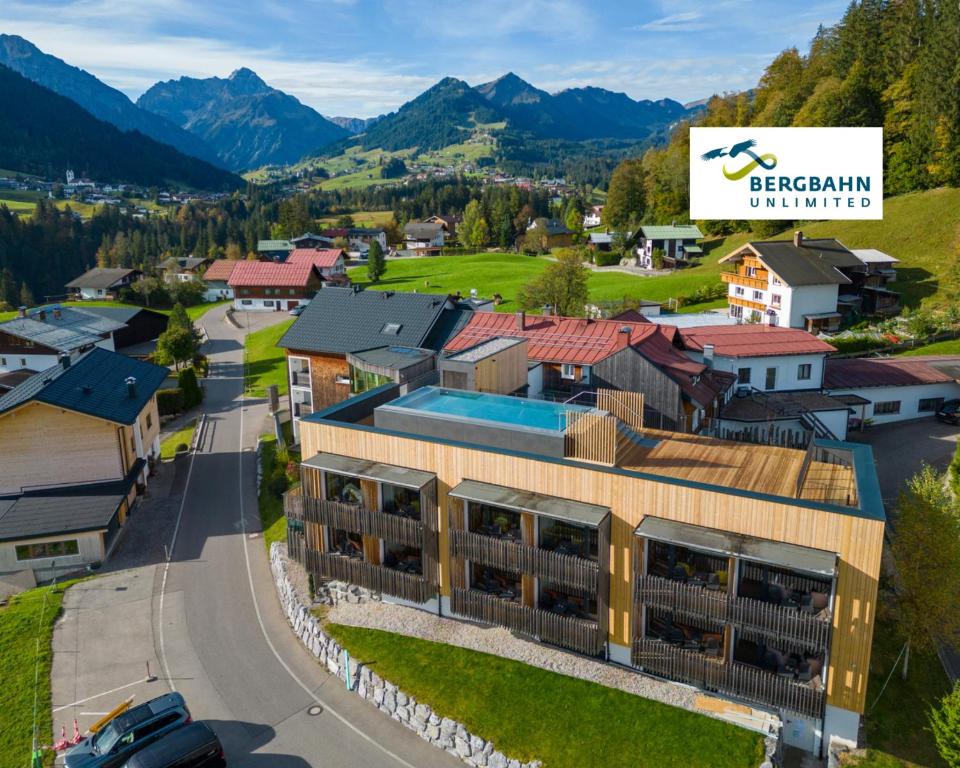 an aerial view of a small town with mountains at Genuss- & Aktivhotel Sonnenburg in Riezlern