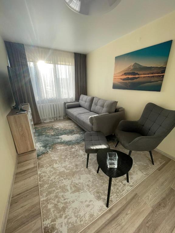 a living room with a couch and a table at Comfort Haven Apartments in Jõhvi