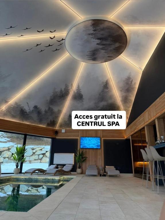 a lobby with a swimming pool and birds on the ceiling at Rodnei Retreat & Spa in Borşa