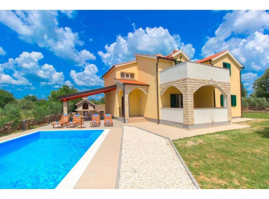 a villa with a swimming pool and a house at Villa Dalmacija in Drniš