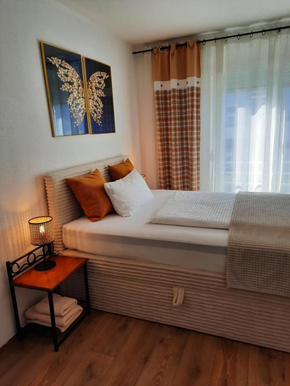 a bedroom with a large bed and a window at Augsburg!Möblierte Appartment! in Augsburg