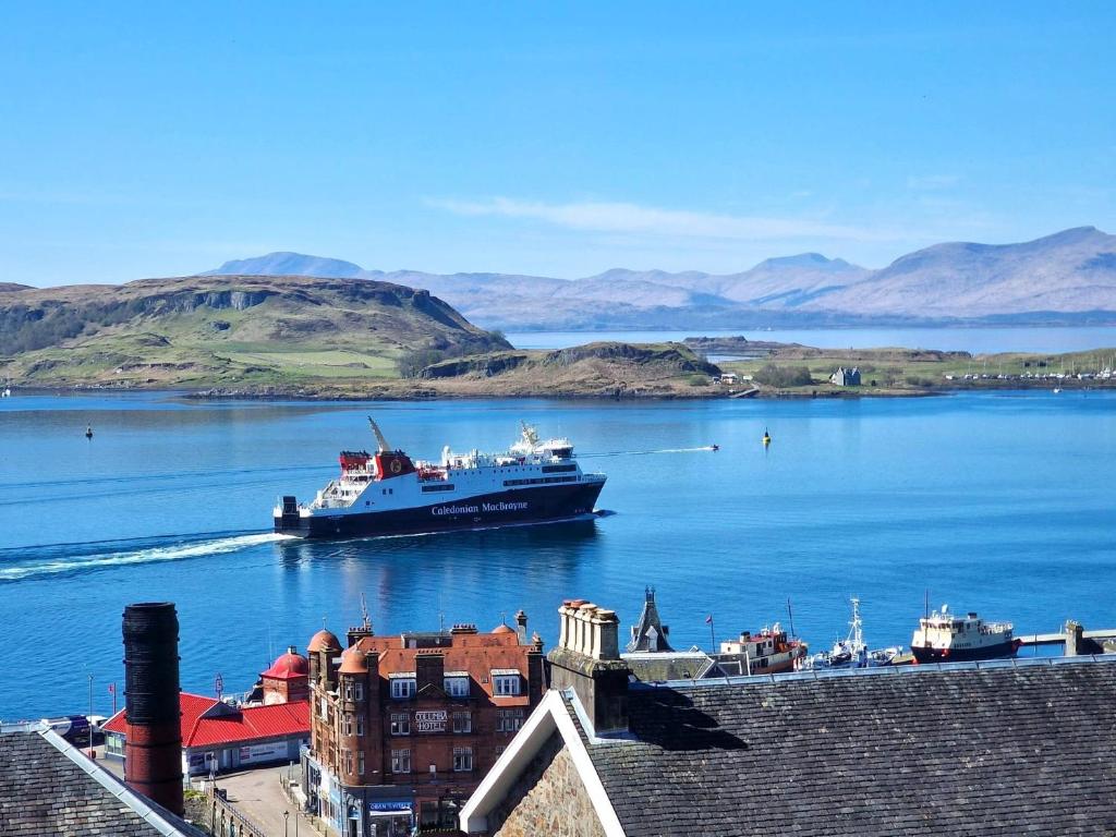a large boat in a large body of water at McCaig's Tower Apartment in Oban