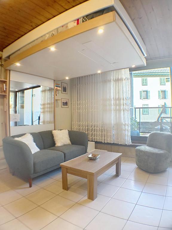 a living room with a couch and a coffee table at Ladybird Inn in Chamonix