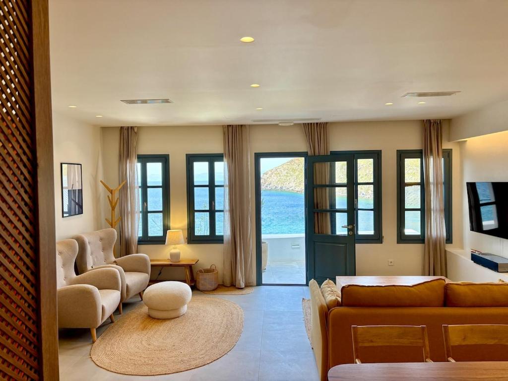 a living room with a couch and chairs at Patmos Cliff House in Patmos