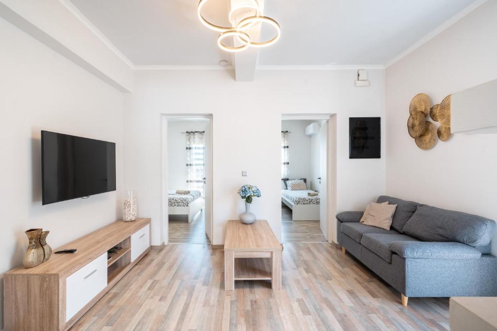 a living room with a couch and a tv at Dimasti Apartment in Rhodes Town