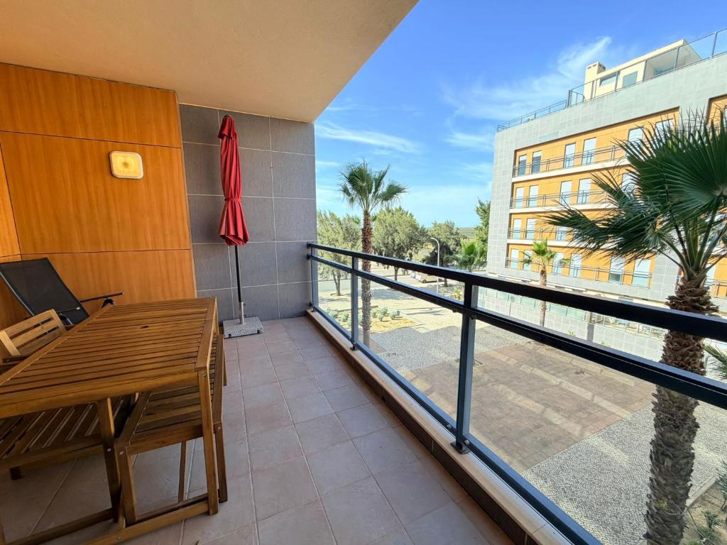 a balcony with a table and a view of a building at Casa Joaninha in Olhão