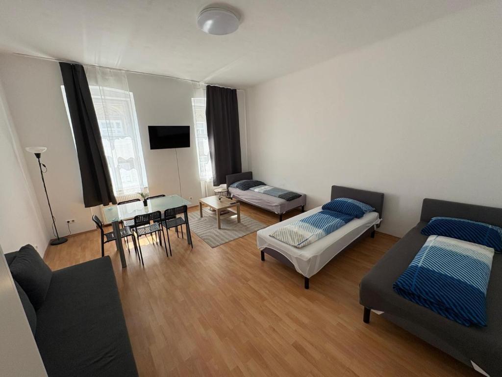 a living room with a bed and a table at Palace Apartment in Vienna