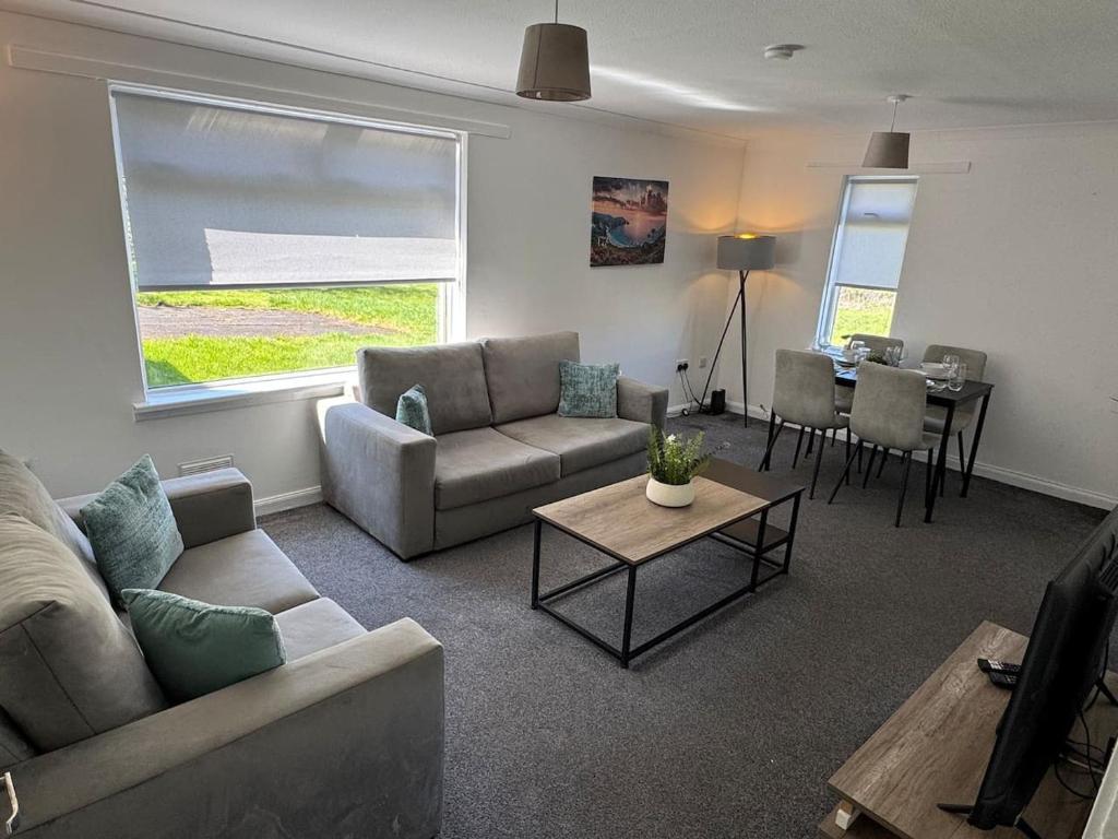 a living room with a couch and a table at Chapelhall Contractor Stay in Chapelhall