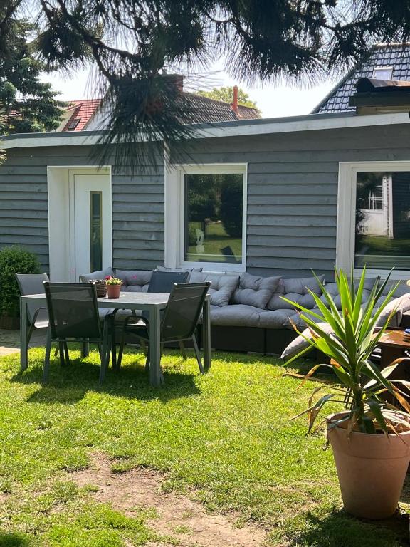 a patio with a couch and a table and chairs at ZurAlten Bank Fewo 4 in Altenkirchen