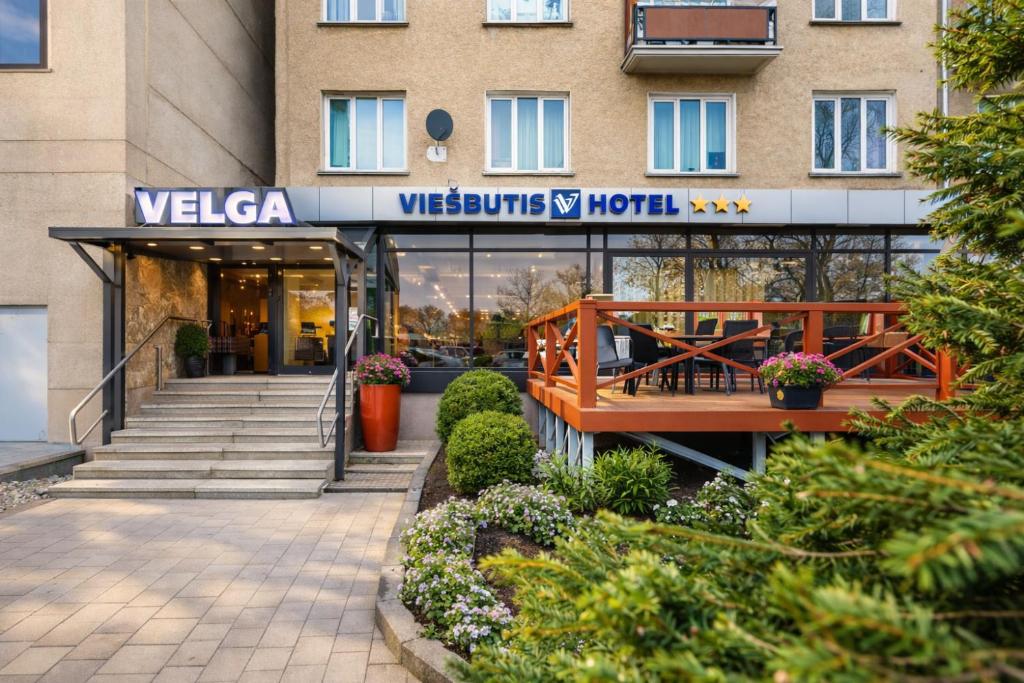 a building with a welcome sign in front of it at Velga in Vilnius
