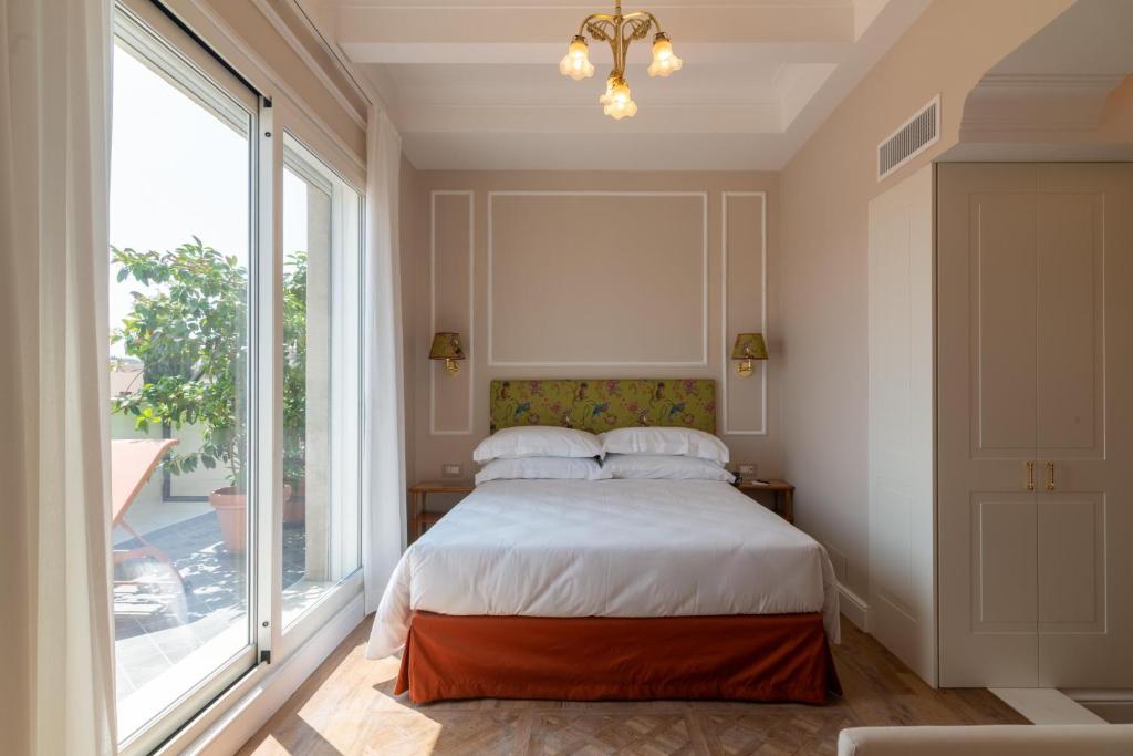 a bedroom with a bed and a large window at Best Western Hotel Rivoli in Rome