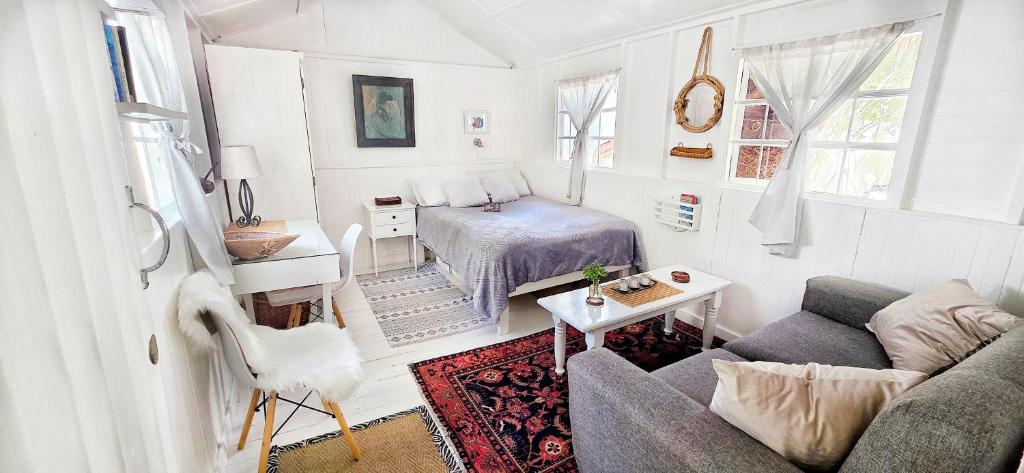 a small living room with a couch and a bed at Oh so Heavenly in Cape Town