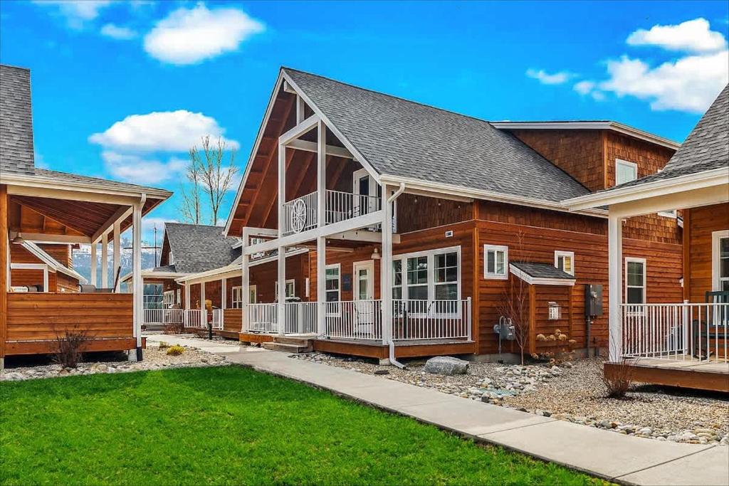 a log home with a porch and a house at Comfy & close to Lake Pend Oreille & Schweitzer in Dover