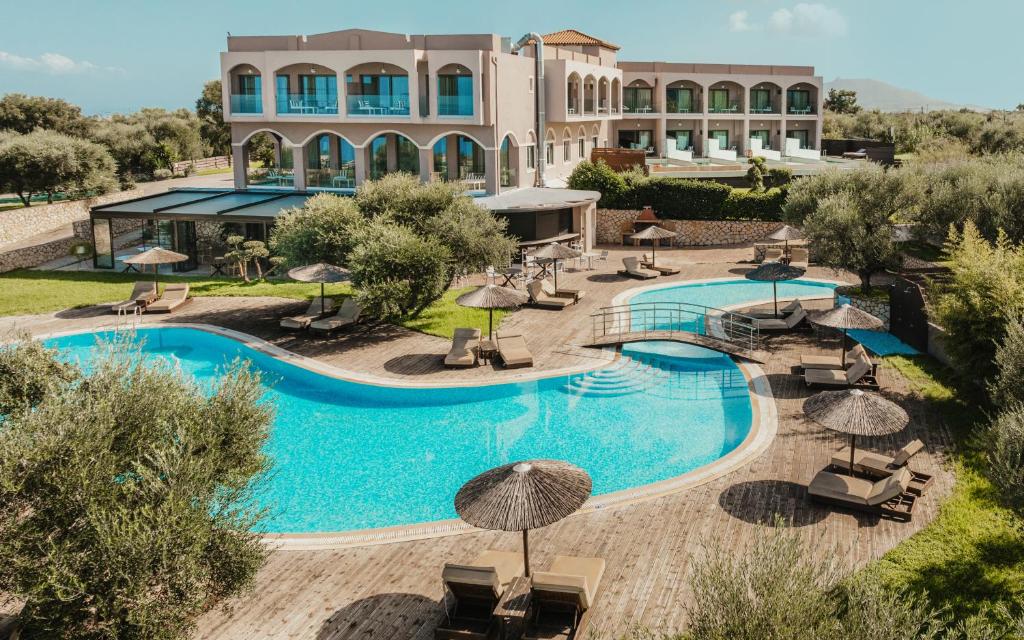 an image of a resort pool with umbrellas at Elegance Luxury Executive Suites - Adults Only in Tragaki