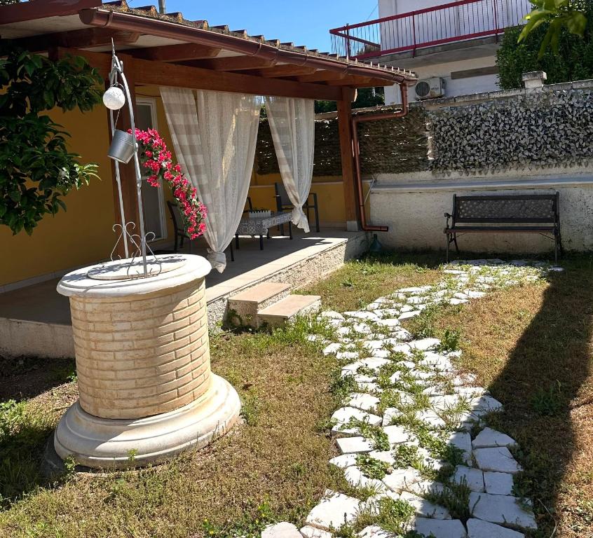a brick fountain in the yard of a house at Villa Dependance in Taranto