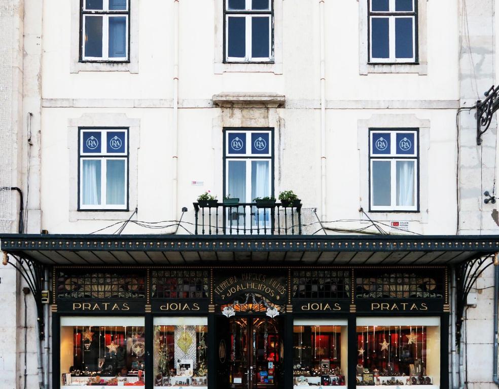 a store in front of a white building at Rossio Apartments in Lisbon