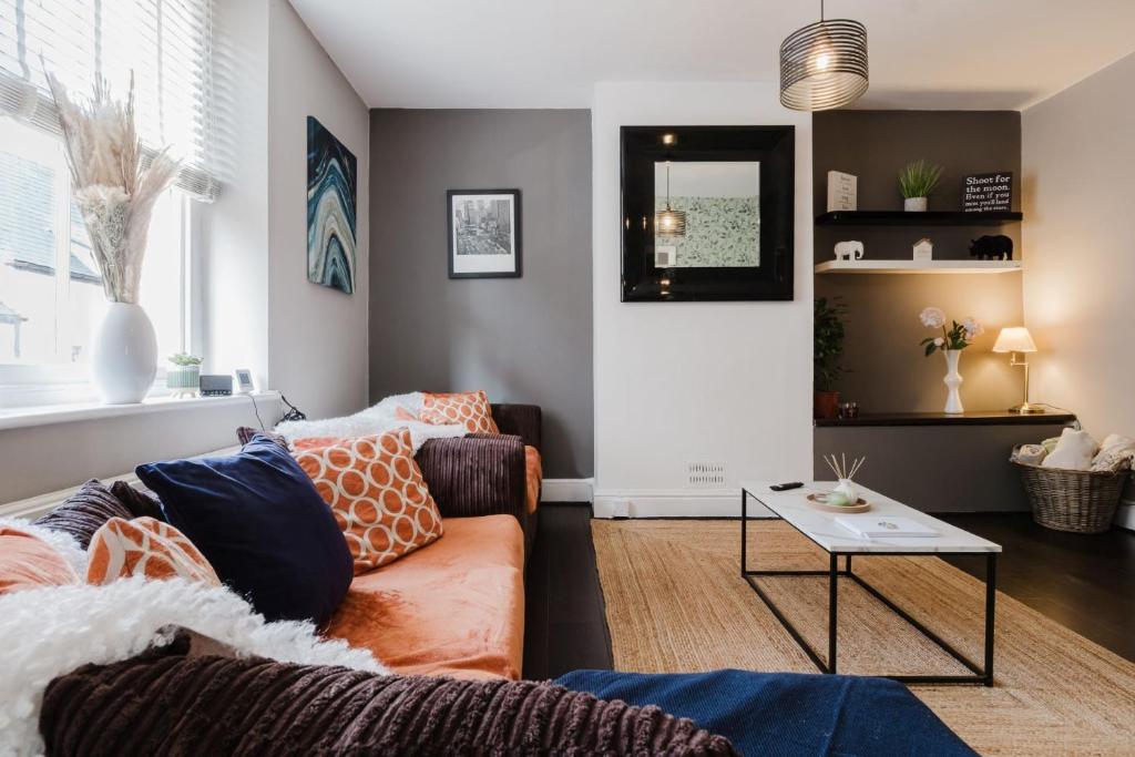 a living room with a couch and a table at Licata's Apartment in Cirencester