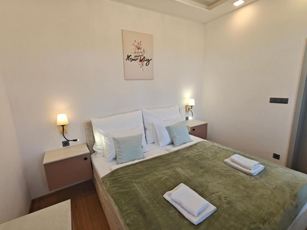 a bedroom with a large bed with two towels on it at Apartmány Promenáda in Trutnov
