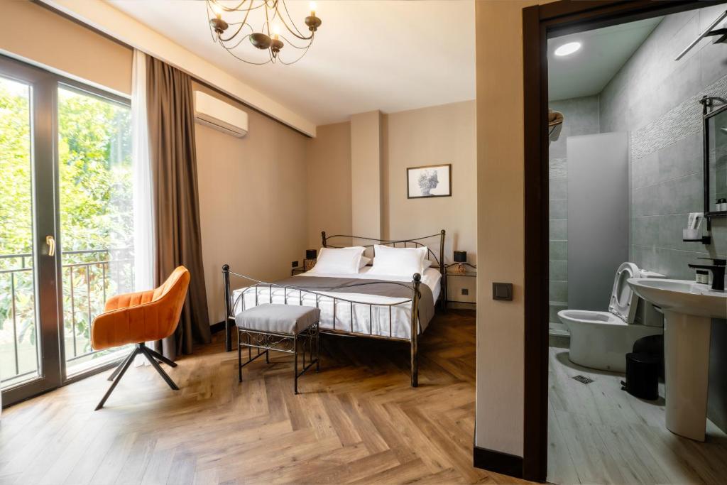 a bedroom with a bed and a tub and a sink at Golden Boutique Hotel in Tbilisi City