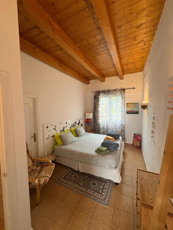 a bedroom with a bed and a wooden ceiling at joy in Lajares