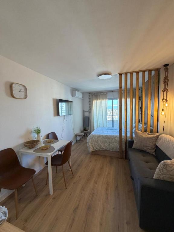 a living room with a bed and a table and a couch at Tamy-Home in Empuriabrava