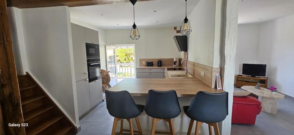 a kitchen and dining room with a table and chairs at Maison d' Adèlbraz in Voulaines